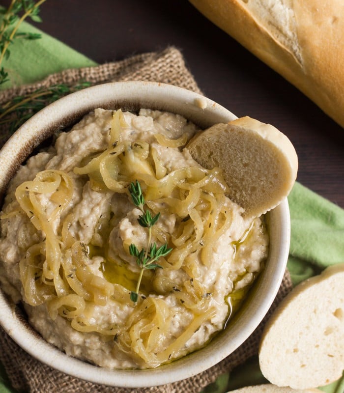 Overhead View of a Bowl of Caramelized Onion Hummus with Bread