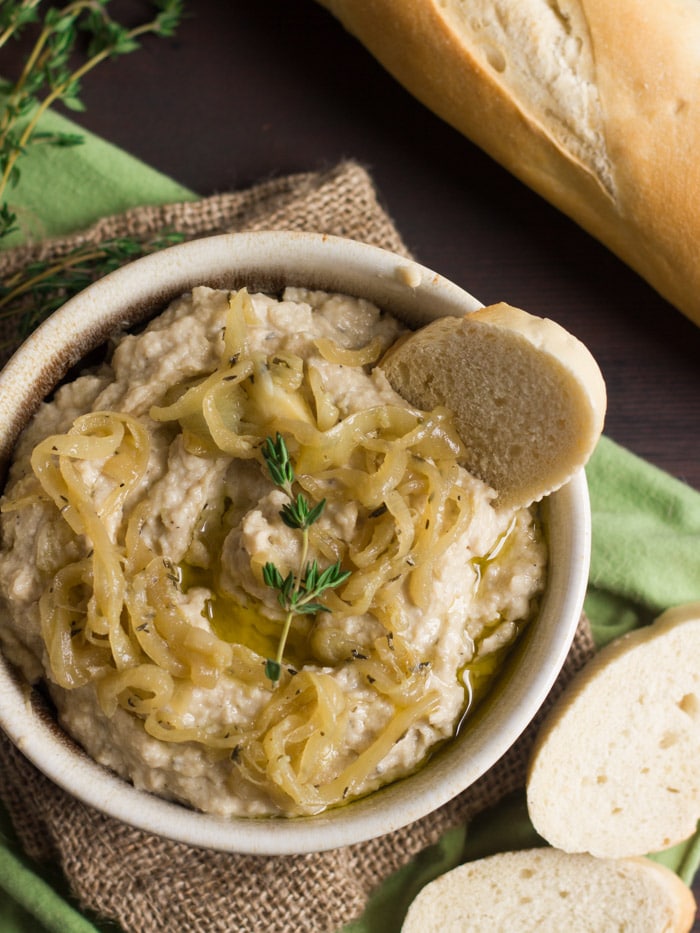 Overhead View of a Bowl of Caramelized Onion Hummus with Bread