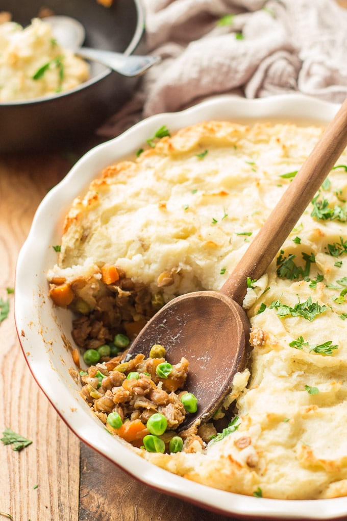 Close Up of a Wooden Spoon Digging into a Vegan Shepherd's Pie