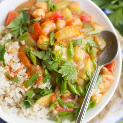 Close up of vegan etouffee in a bowl with rice.