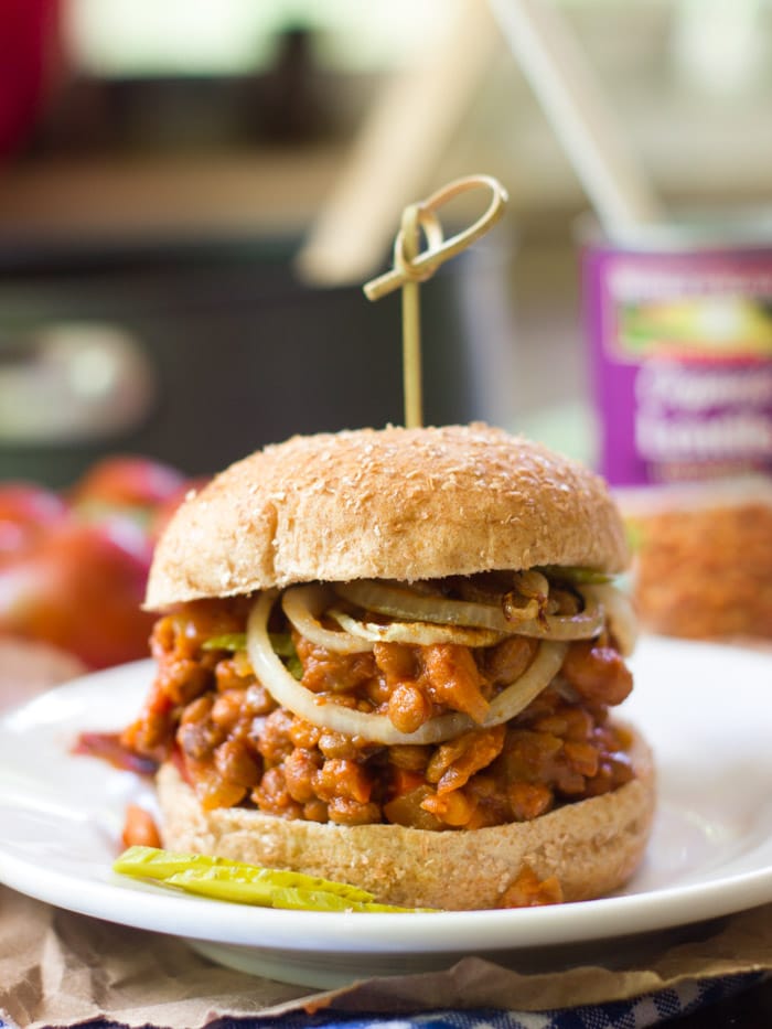 Vegan Sloppy Joe Sandwich on a Plate Topped with Onion Slices