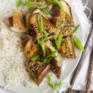 Close up of Miso Glazed Eggplant and Rice on a Plate, Topped with Scallions
