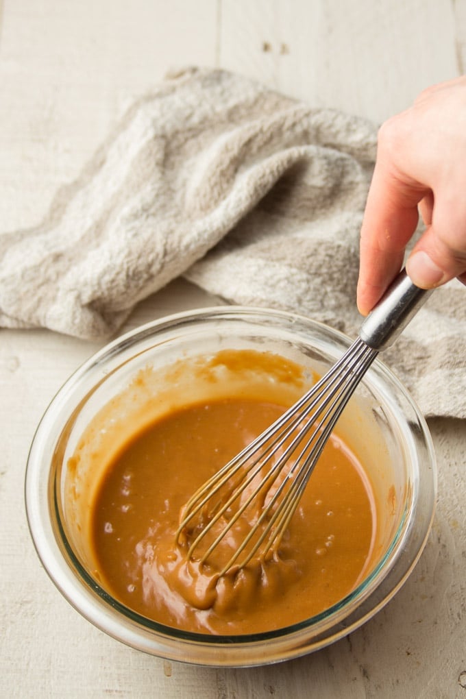 Hand Whisking Peanut Sauce Together in a Bowl