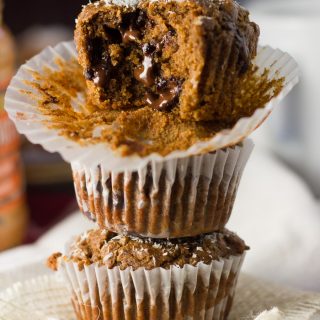 Stack of Three Peanut Butter Blackstrap Muffins, with A Bite Removed From the Top Muffin