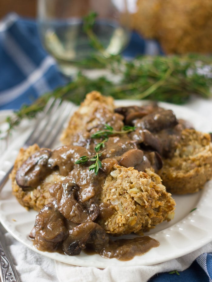 Three Slices of Vegan Meatloaf Topped with Mushroom Gravy on a Plate