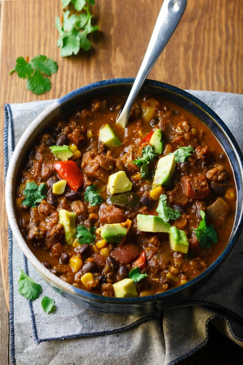 Bowl of Killer Vegan Chili Sitting on a Napkin with Spoon Sticking Out