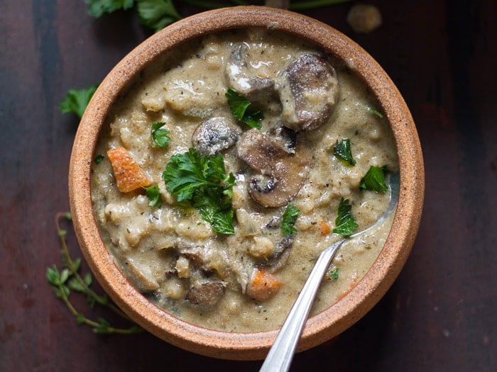 Bowl of Creamy Vegan Mushroom Barley Soup Topped with Parsley