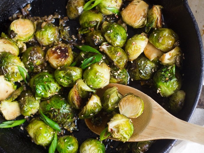 Sweet & Sour Brussels Sprouts in a Skillet with Wooden Spoon