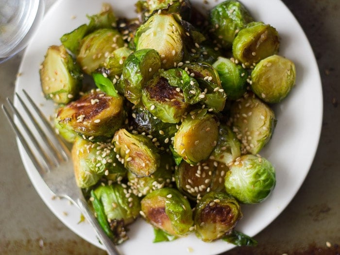 Close Up of a Plate of Sweet & Sour Brussels Sprouts with Fork