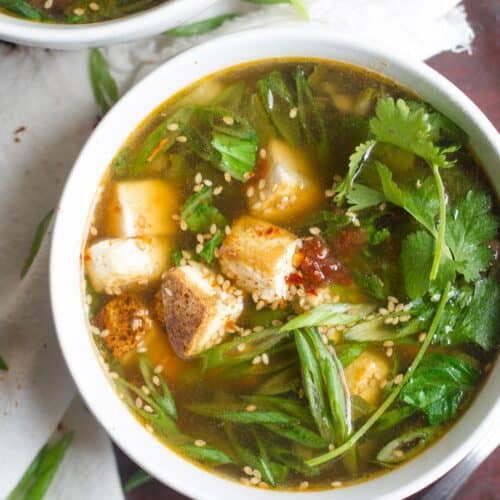 Bowl of vegan hot and sour soup with fresh cilantro on top.
