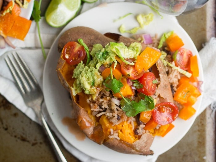 Overhead View of a Burrito Stuffed Sweet Potato on a Plate, Topped with Rustic Salsa