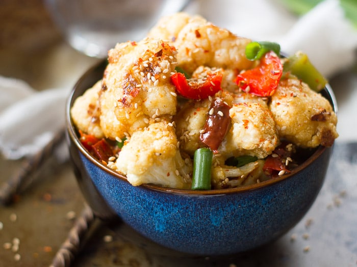 Close Up of a Bowl of Hunan Cauliflower with Chopsticks on the Side