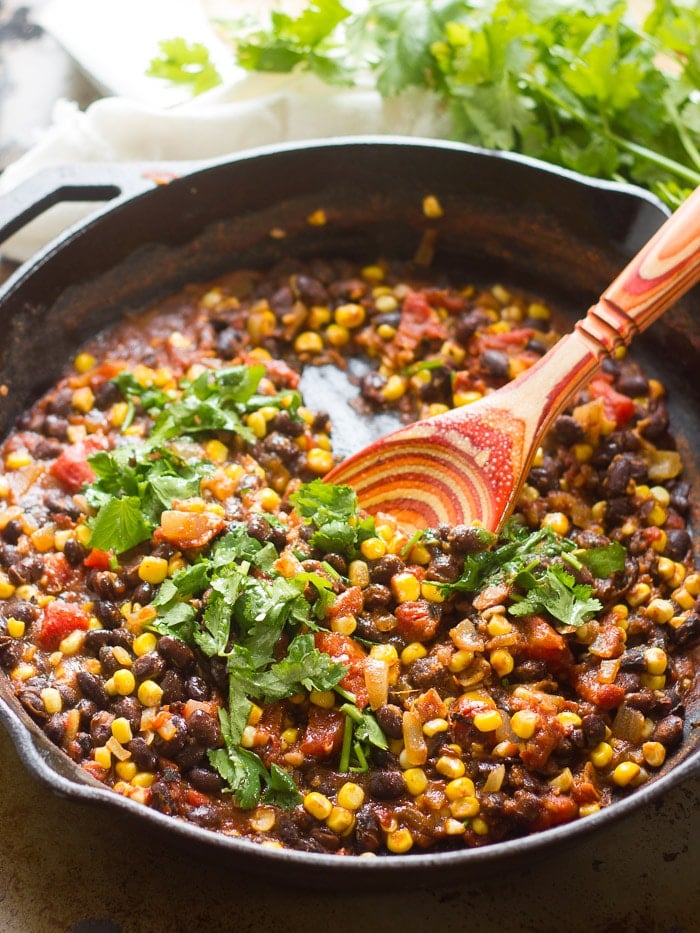 Black Beans, Corn and Seasonings in a Skillet for Making Vegan Chilaquiles