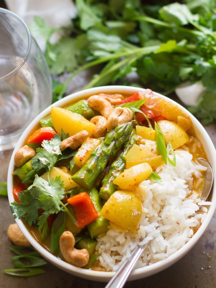 Golden Spring Vegetable Thai Curry in a Bowl with Rice and Spoon