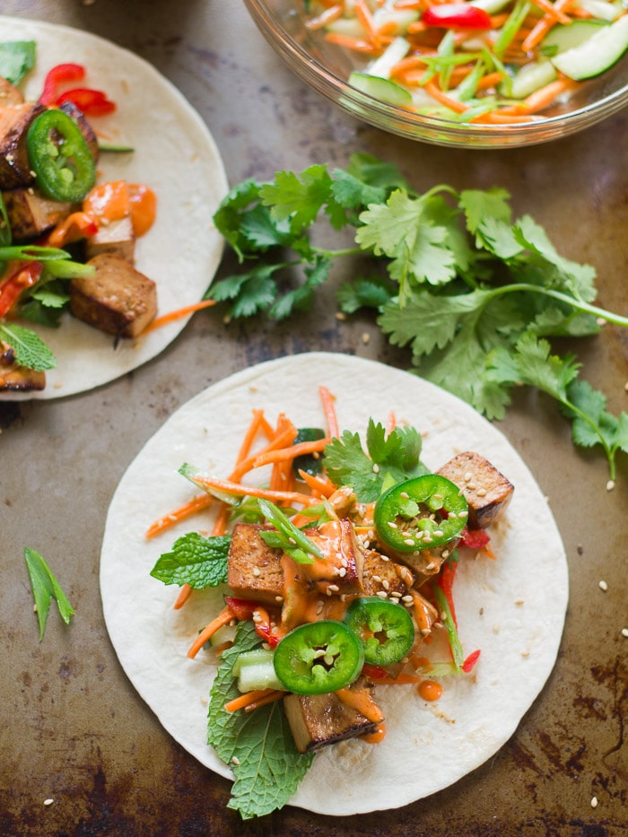Two Tortillas Topped with Smoky Tofu Banh Mi Taco Fillings on a Baking Sheet
