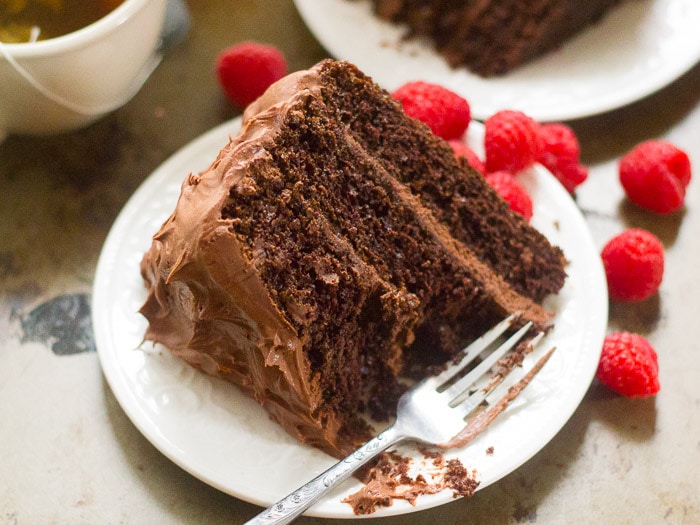 Slice of Vegan Chocolate Mocha Layer Cake on a Plate with a Bite Taken Out