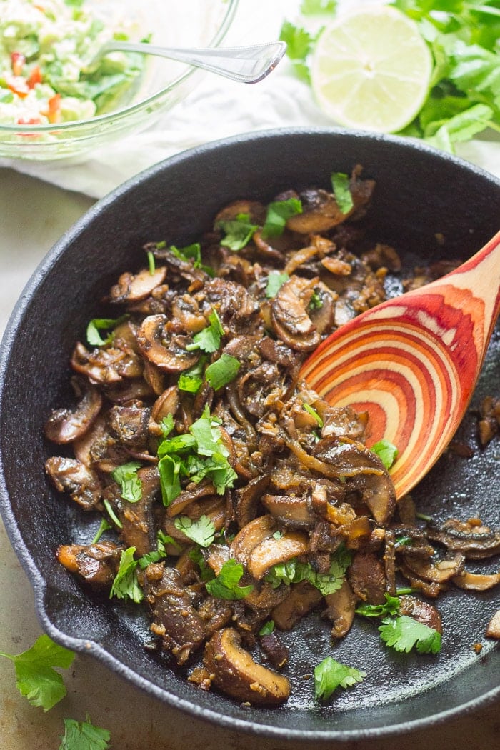 Mushroom Carnitas Taco Filling in a Skillet with Wooden Spoon