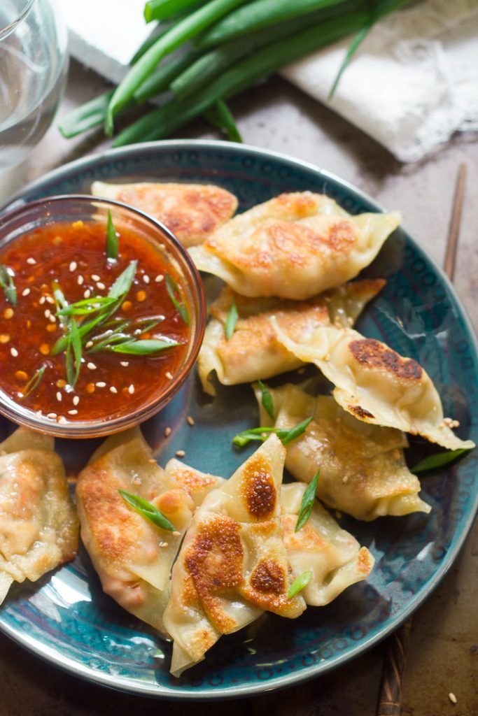 Plate of Smoky Tofu Dumplings with a Bowl of Sweet Chili Dipping Sauce