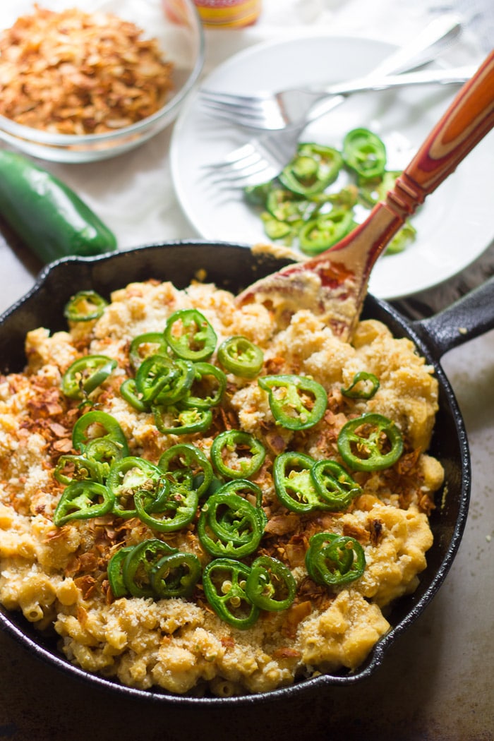 Skillet of Vegan Jalapeño Popper Mac & Cheese with Wooden Spoon