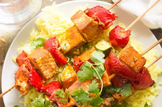 Mediterranean-Spiced Tofu Kebabs Over Rice on a Plate