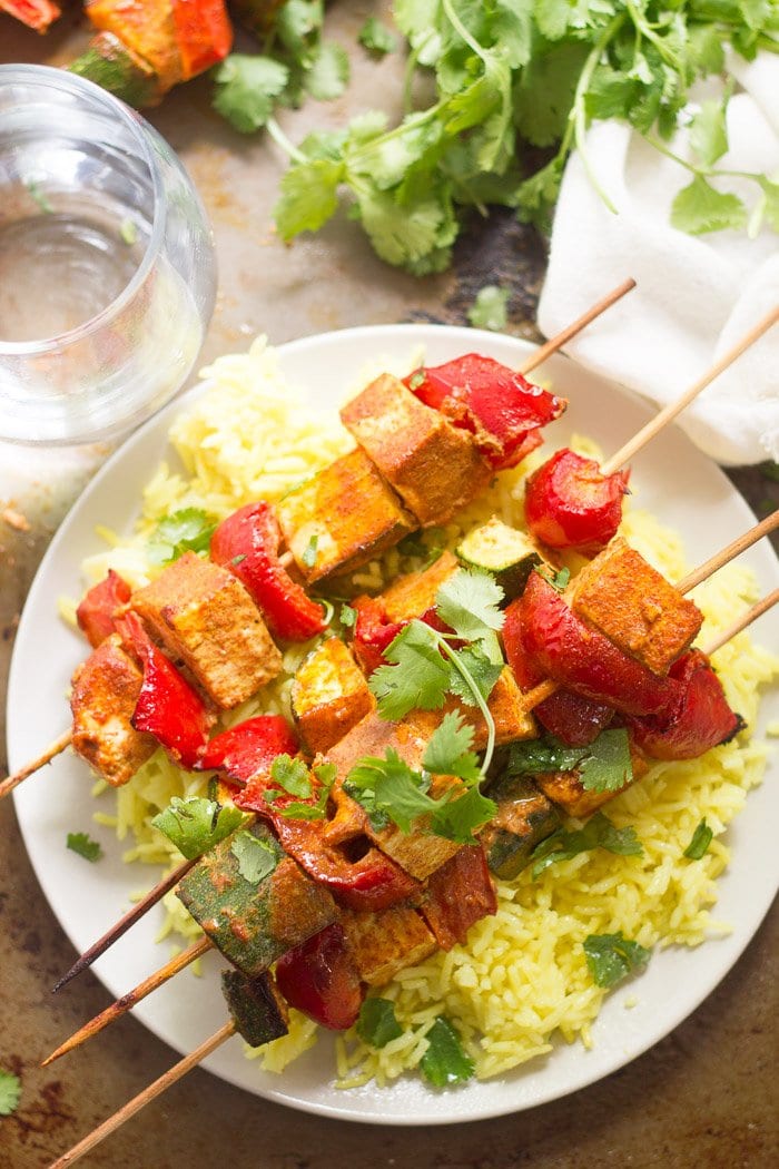 Mediterranean-Spiced Tofu Kebabs Over Rice on a Plate