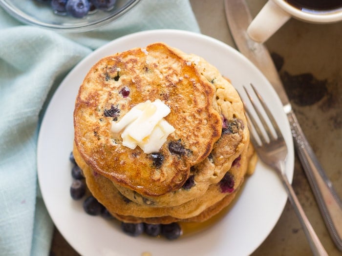 Overhead View of a Plate of Vegan Blueberry Buttermilk Pancakes Topped with Vegan Butter
