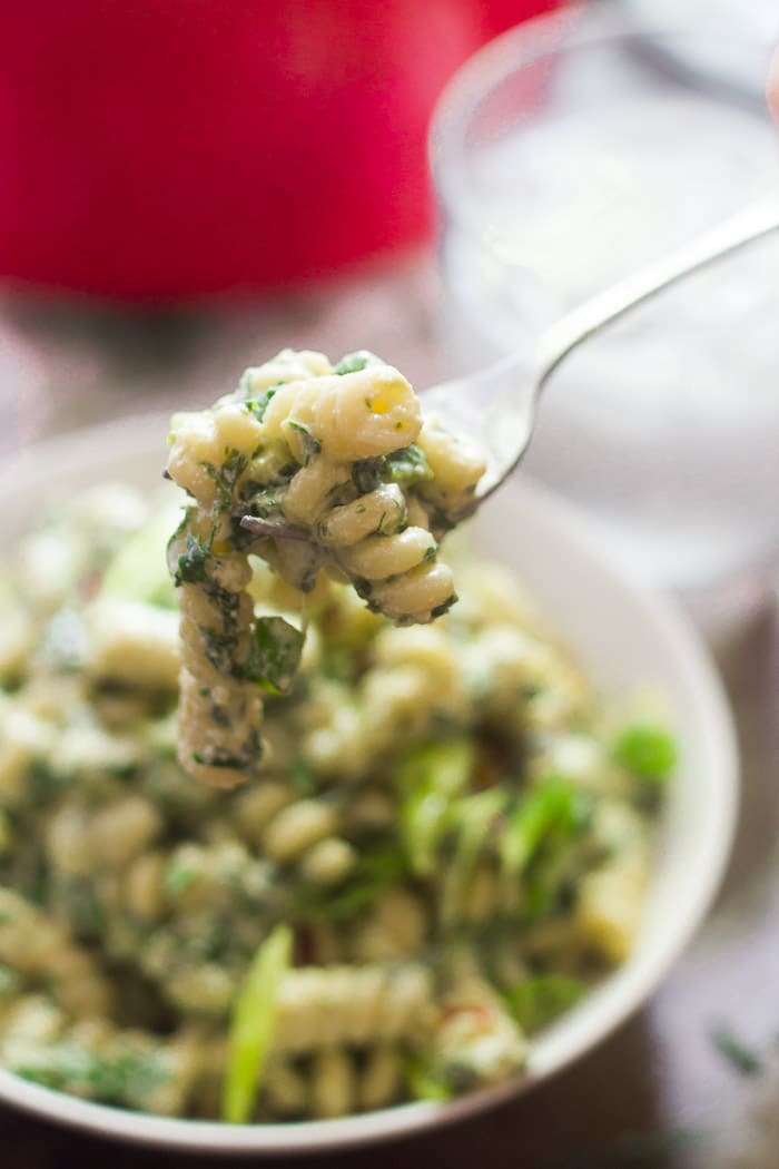 Close Up of Creamy Vegan Spinach Pasta Held on a Fork