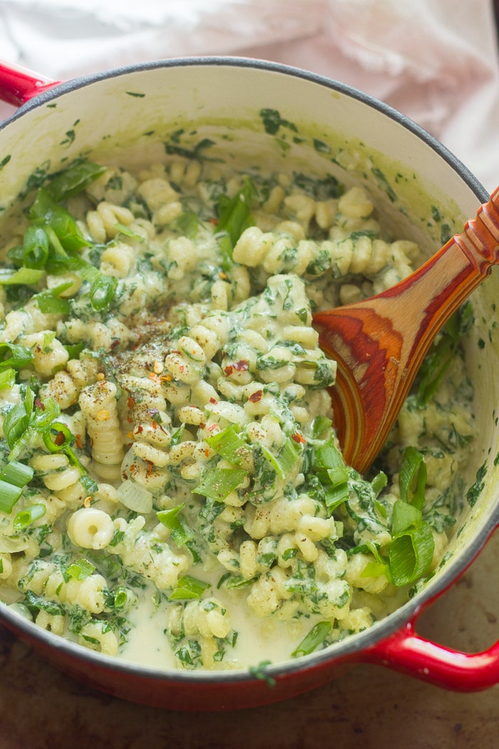 Pot of Creamy Vegan Spinach Pasta with Wooden Spoon