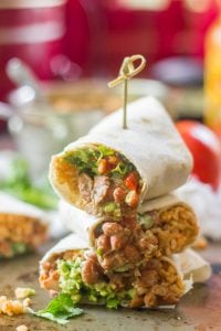 Three 7 Layer Burrito Halves Stacked and Held Together with a Skewer