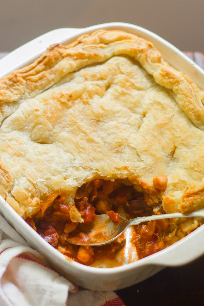 Chickpea Ragoût Pot Pie in a Casserole Dish with a Slice Cut Out