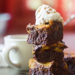 Stack of Three Vegan Pumpkin Cheesecake Brownies Topped with a Scoop of Ice Cream