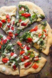 Slices of Vegan Spinach & Artichoke White Pizza on a Baking Sheet
