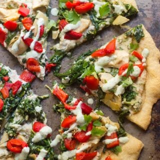 Slices of Vegan Spinach & Artichoke White Pizza on a Baking Sheet