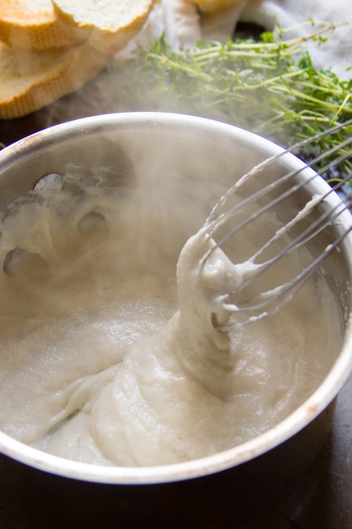 Wire Whisk Mixing Vegan Mozzarella in a Saucepan