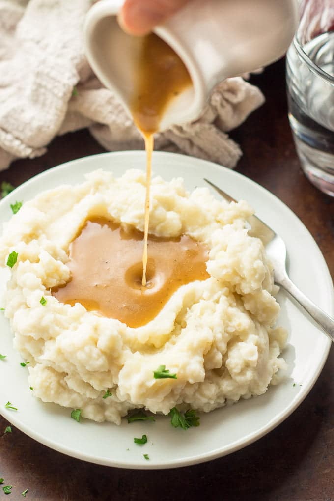 Vegan Gravy Being Poured on a Mound of Mashed Potatoes