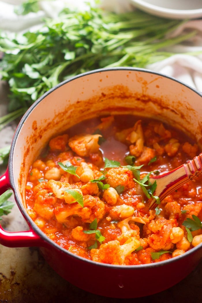Cauliflower & Chickpea Stew in a Pot with Wooden Spoon
