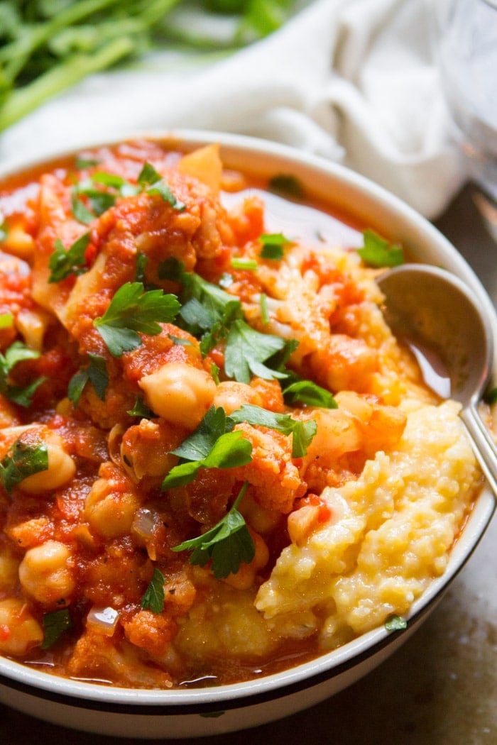 Close Up of Cauliflower Chickpea Stew Over Creamy Polenta in a Bowl