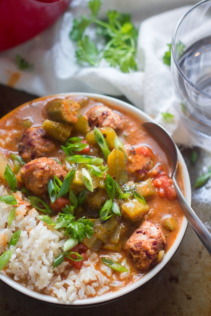 Close Up of a Bowl of Vegan Gumbo with Andouille Red Bean Meatballs with Spoon