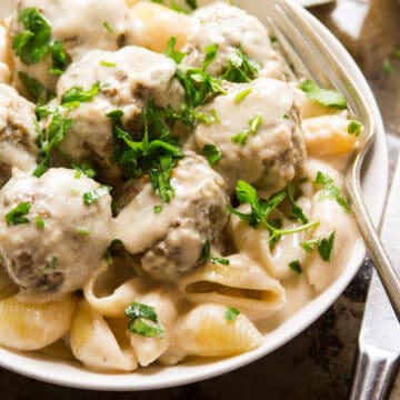 Close up of vegan Swedish meatballs and pasta in a bowl.