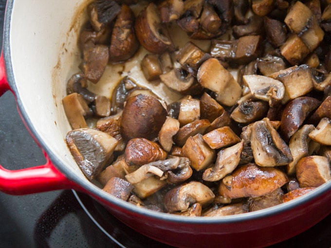 Mushrooms Sizzling in a Pot to Make Vegan Irish Stew with Savory Herb Dumplings