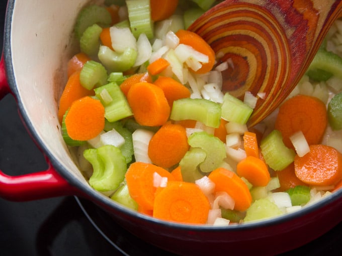 Carrots, Onions and Celery Sizzling in a Pot to Make Vegan Irish Stew with Savory Herb Dumplings