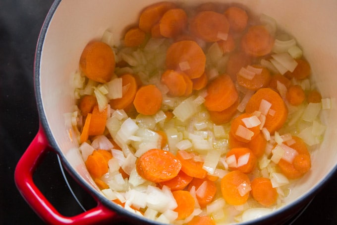 Carrots and Onions Sizzling in Oil to Make Vegan Pasta Primavera