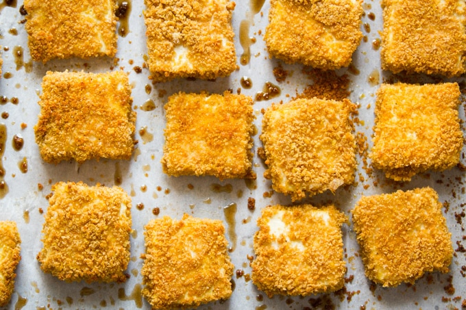 Crispy Baked Tofu Nuggets Just Out of the Oven Arranged on Parchment Paper