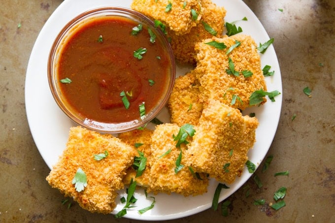 Overhead View of Crispy Baked Tofu Nuggets on a Plate with Dipping Sauce