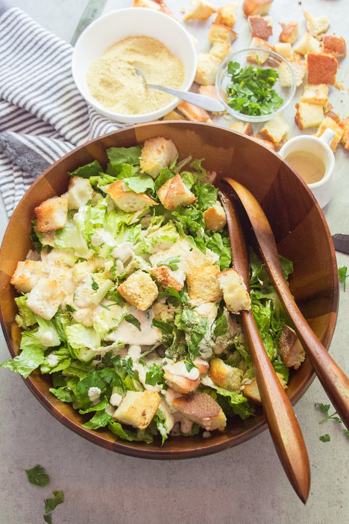 Vegan Caesar Salad in Serving Bowl with Wooden Serving Spoons