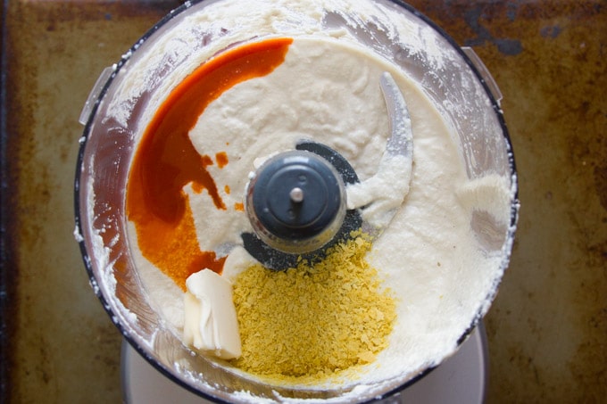 Cashew Cream, Vegan Butter, Hot Sauce and Nutritional Yeast in a Food Processor For Making Vegan Twice Baked Potatoes