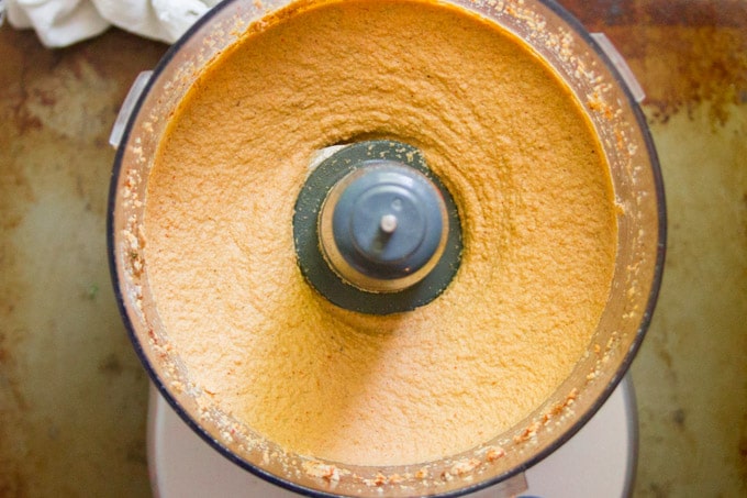 Food Processor Bowl Filled with Spiced Cashew Cheese for Making Cheesy Vegan Taco Dip
