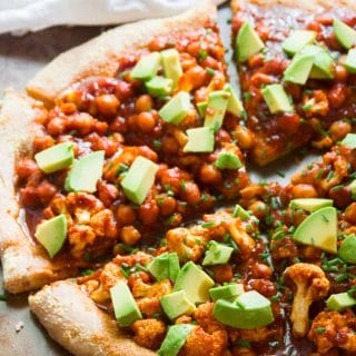 Close Up of a Barbecue Chickpea & Cauliflower Pizza with a Napkin in the Background