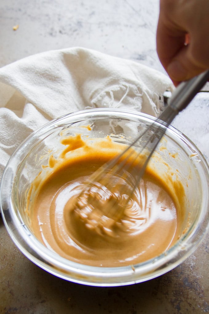 Whisking Peanut Sauce in a Bowl to Make Sesame Peanut Noodles