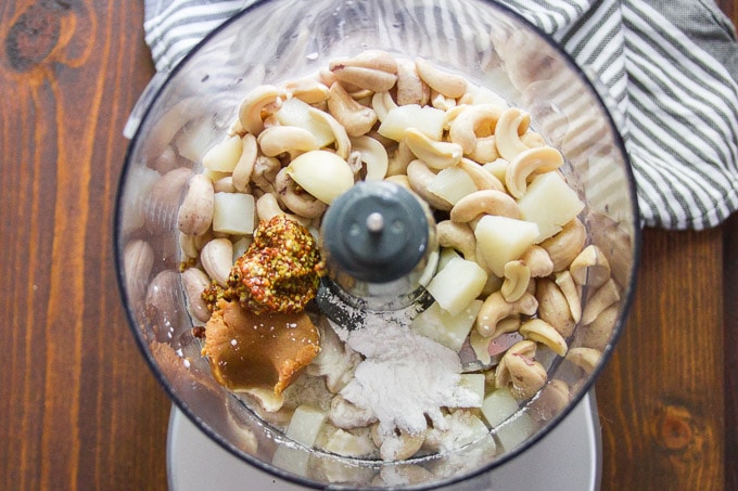 Food Processor Filled with Ingredients for Making Vegan Swiss Cheese Fondue